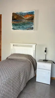 a bedroom with a bed and a painting on the wall at Shakti in Almafuerte