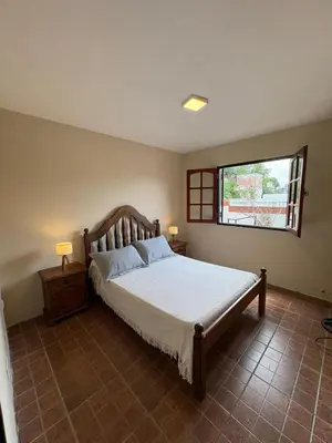 a bedroom with a large bed and a window at Complejo Zara in Villa Carlos Paz