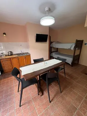 a room with a table and chairs and a bed at Complejo Zara in Villa Carlos Paz