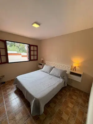 a bedroom with a large bed with a window at Complejo Zara in Villa Carlos Paz