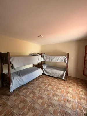 three bunk beds in a room with a tiled floor at Complejo Zara in Villa Carlos Paz
