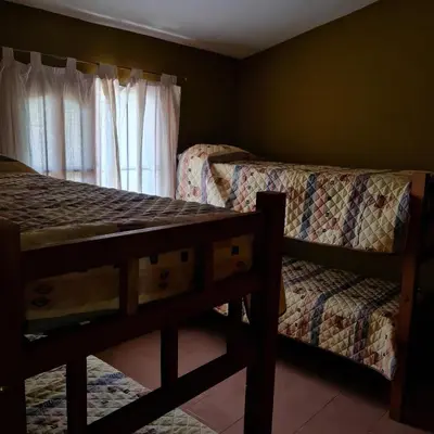 a bedroom with two bunk beds and a window at Complejo Ayllu in Las Rabonas
