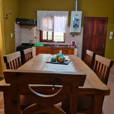 a kitchen with a wooden table with fruit on it at Complejo Ayllu in Las Rabonas