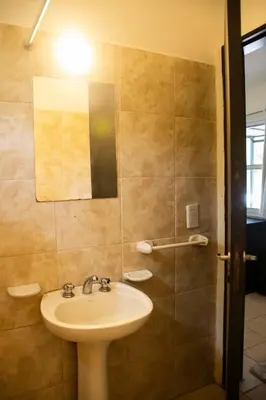 a bathroom with a sink and a shower at Alma Petra - Cabañas en Cabalango, Tanti, Punilla in Estancia Vieja