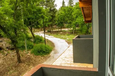 a view of a walkway from a window of a house at Alma Petra - Cabañas en Cabalango, Tanti, Punilla in Estancia Vieja