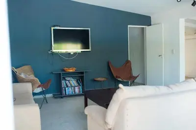 a living room with a tv on a blue wall at Casa Potrero de Garay in La Estancia