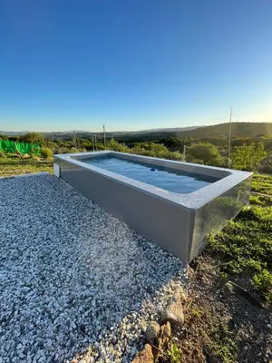 a swimming pool on top of a pile of rocks at Entre Sierras Cabañas in Tanti
