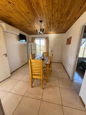 a kitchen and dining room with a table and chairs at Balcones del Cristal - Picaflor in Tanti