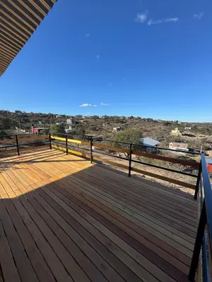 a wooden deck with a view of the beach at Balcones del Cristal - Picaflor in Tanti