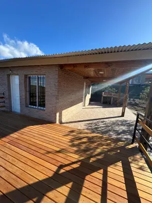 a deck of a house with a bench on it at Balcones del Cristal - Picaflor in Tanti