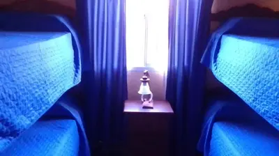 a small figurine sitting on a table in front of a window at Cabañas Ojo de Agua in Trapiche