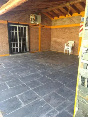 an empty patio with a basketball hoop on a brick wall at Cabañas Ojo de Agua in Trapiche