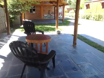 two chairs and a table on a patio at Cabañas Ojo de Agua in Trapiche