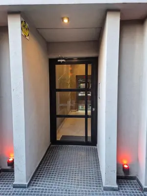 an entrance to a building with a glass door at Oasis Urbano - bello departamento amoblado en la mejor zona de Guemes in Cordoba