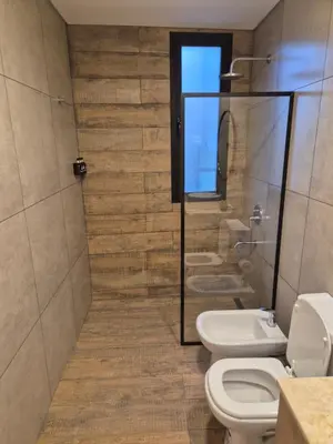 a bathroom with two toilets and a shower at Oasis Urbano - bello departamento amoblado en la mejor zona de Guemes in Cordoba