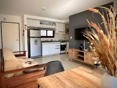 a living room with a couch and a table at Departamento con piscina General Paz in Cordoba