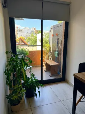 a room with a view of a balcony with plants at Departamento con piscina General Paz in Cordoba