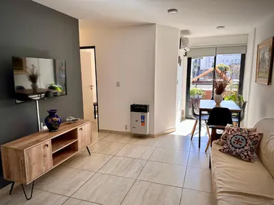 a living room with a couch and a table at Departamento con piscina General Paz in Cordoba