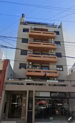 a tall building with balconies on the side of it at Departamento con piscina General Paz in Cordoba