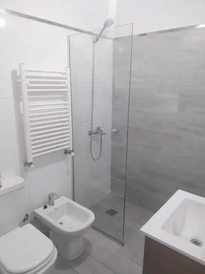a bathroom with a shower and a toilet and a sink at Las Pircas PB in Alta Gracia