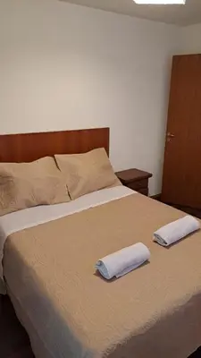 a bedroom with a bed with two towels on it at CBA Apart in Cordoba