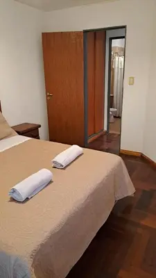a bedroom with a bed with two towels on it at CBA Apart in Cordoba