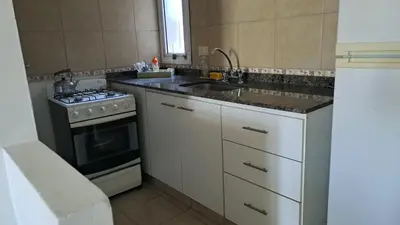 a kitchen with a stove and a sink at CBA Apart in Cordoba