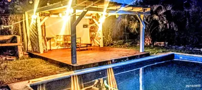 a house with a deck next to a swimming pool at Nuevos Aires in Los Reartes