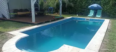 a swimming pool with blue water in a yard at Nuevos Aires in Los Reartes