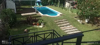 a backyard with a swimming pool and a yard with a fence at Nuevos Aires in Los Reartes