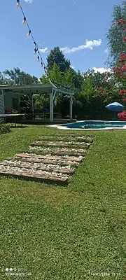 a group of stepping stones on the grass near a pool at Nuevos Aires in Los Reartes