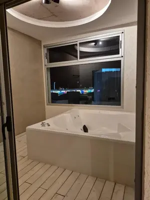 a bath tub in a room with a window at ALOJATE PREMIUM VILLA CARL0S PAZ - STEFANO 1 dor in Villa Carlos Paz