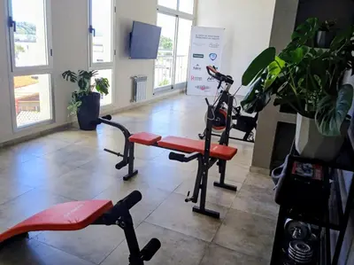a gym with a treadmill and a exercise bike at ALOJATE PREMIUM VILLA CARL0S PAZ - STEFANO 1 dor in Villa Carlos Paz