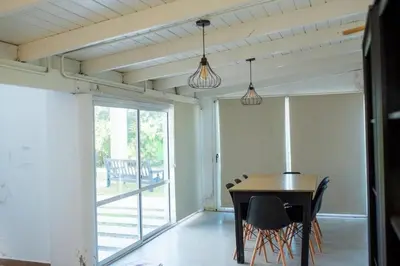 a dining room with a table and chairs at Casa Potrero de Garay pileta in La Estancia