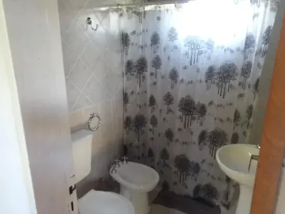 a bathroom with a toilet and a sink at Sierras y sol in Villa Cura Brochero