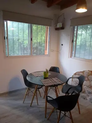 a dining room with a table and four chairs at La tranquera in Trapiche