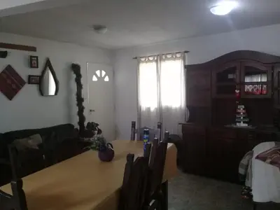 a living room with a table and a couch at Cactus in Villa Carlos Paz