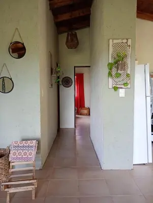 a hallway of a house with a table and a chair at El Chañar in Cordoba