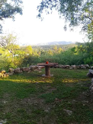 a picnic table sitting in the middle of a field at El Chañar in Cordoba