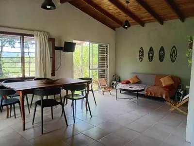 a living room with a table and a couch at El Chañar in Cordoba