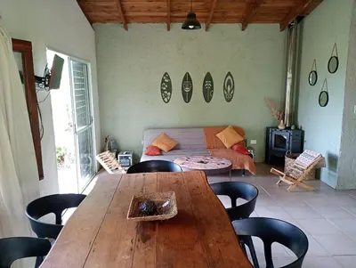 a living room with a wooden table and chairs at El Chañar in Cordoba