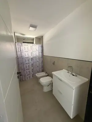 a bathroom with a sink and a toilet at Departamentos Cañitas in Malagueño