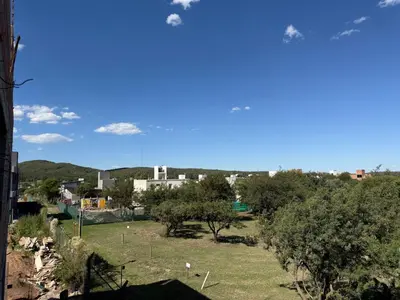 a view of a park with trees and buildings at Departamentos Cañitas in Malagueño
