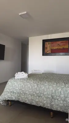 a bedroom with a bed with a blanket on it at Monoambiente Cañitas in Malagueño