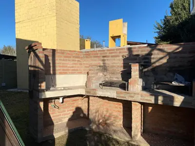 a brick wall with an outdoor oven on it at Complejo alpinas del valle in Santa Rosa de Calamuchita