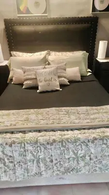 a large bed with pillows on top of it at Departamento de lujo, todo confort, en el corazón de zona norte in Cordoba