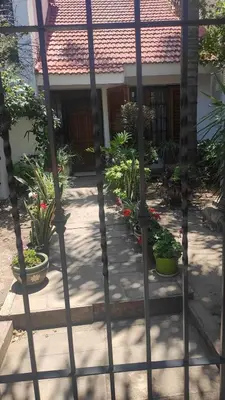 a gate in front of a house with potted plants at Departamento de lujo, todo confort, en el corazón de zona norte in Cordoba