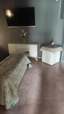 a bedroom with a bed and a tv on the wall at Departamento de lujo, todo confort, en el corazón de zona norte in Cordoba