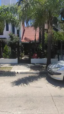 a white car parked in front of a black fence at Departamento de lujo, todo confort, en el corazón de zona norte in Cordoba