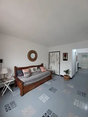 a living room with a bed and a table at Achalay in Bialet Massé